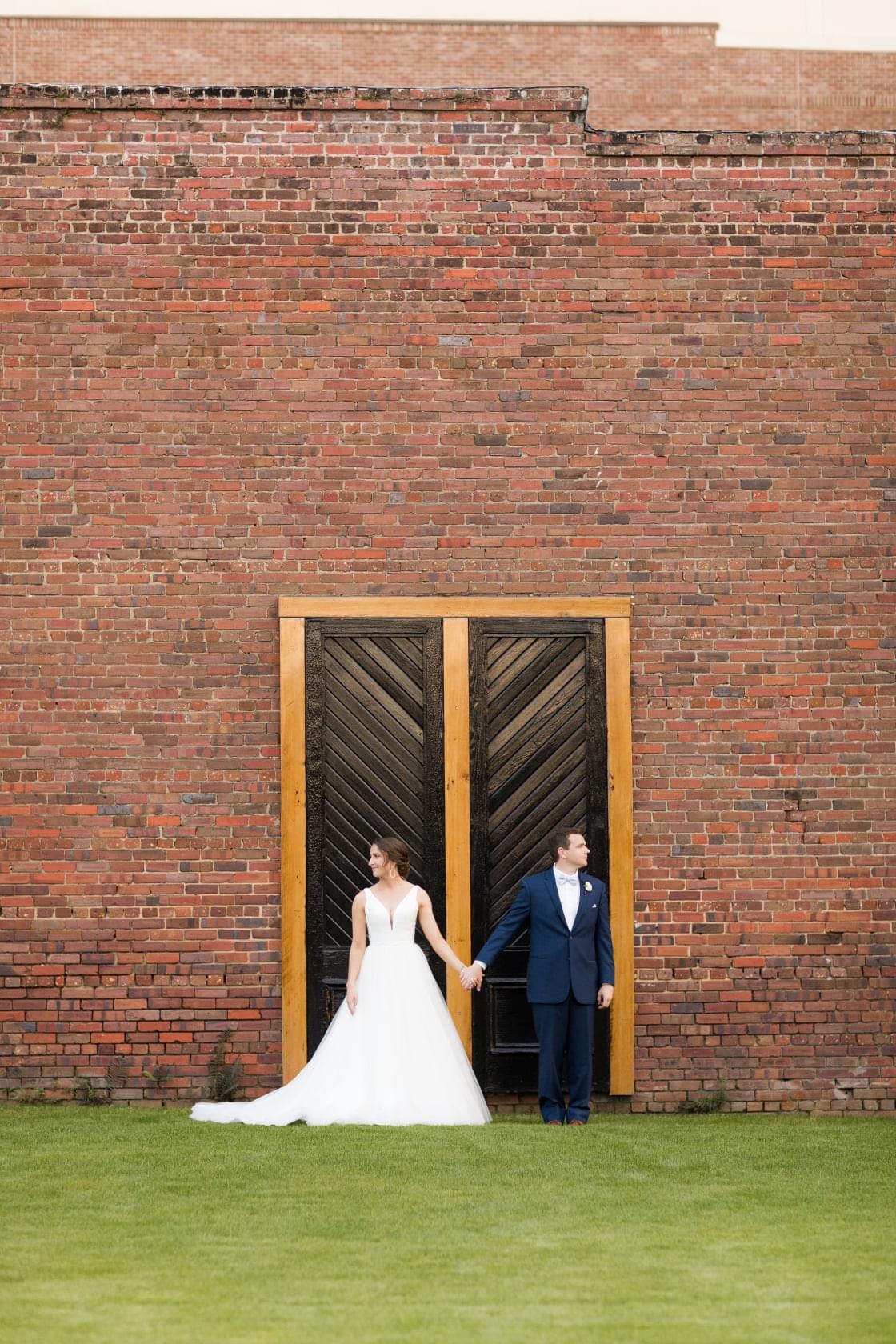 wedding venues pensacola with Bride and Groom in front of iconic black doors