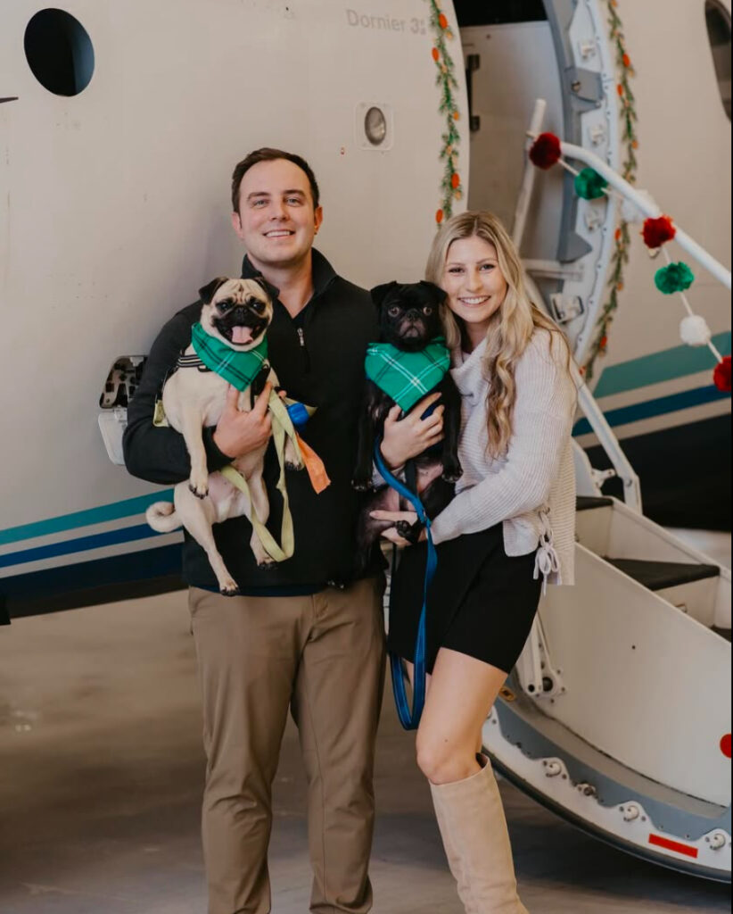 Destin couple with doggies and airplane selecting best month for them which was February for their best month for their wedding in Pensacola & SE United States