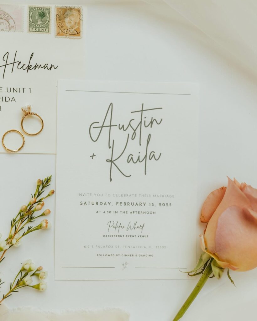 Real bride invitation flat lay with wedding rings at wedding venue pensacola palafox wharf waterfront wedding venue