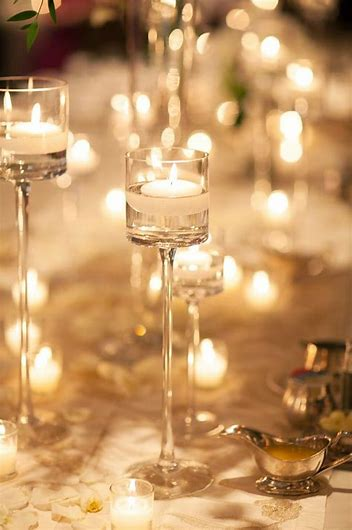 Romantic floating candles in hand-blown glass stemmed candle holders great wedding idea Start Saving Inspiration 
