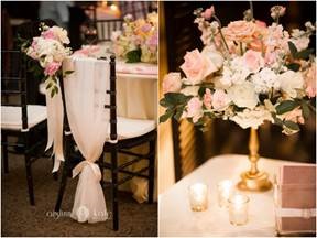 Wedding couple's chairs decorated with florals and sheer with ribbon and beautiful pink and white flowers in gold candle stock vase for centerpiece at Palafox Wharf Waterfront is a beautiful example to put in your wedding ideas collection Start Saving Inspiration 