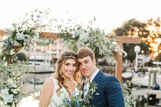 Just Married! Photo of Wedding bride & green in front of their wedding arbor on the green at Palafox Wharf Waterfront on the Emerald Coast in Pensacola, Florida
