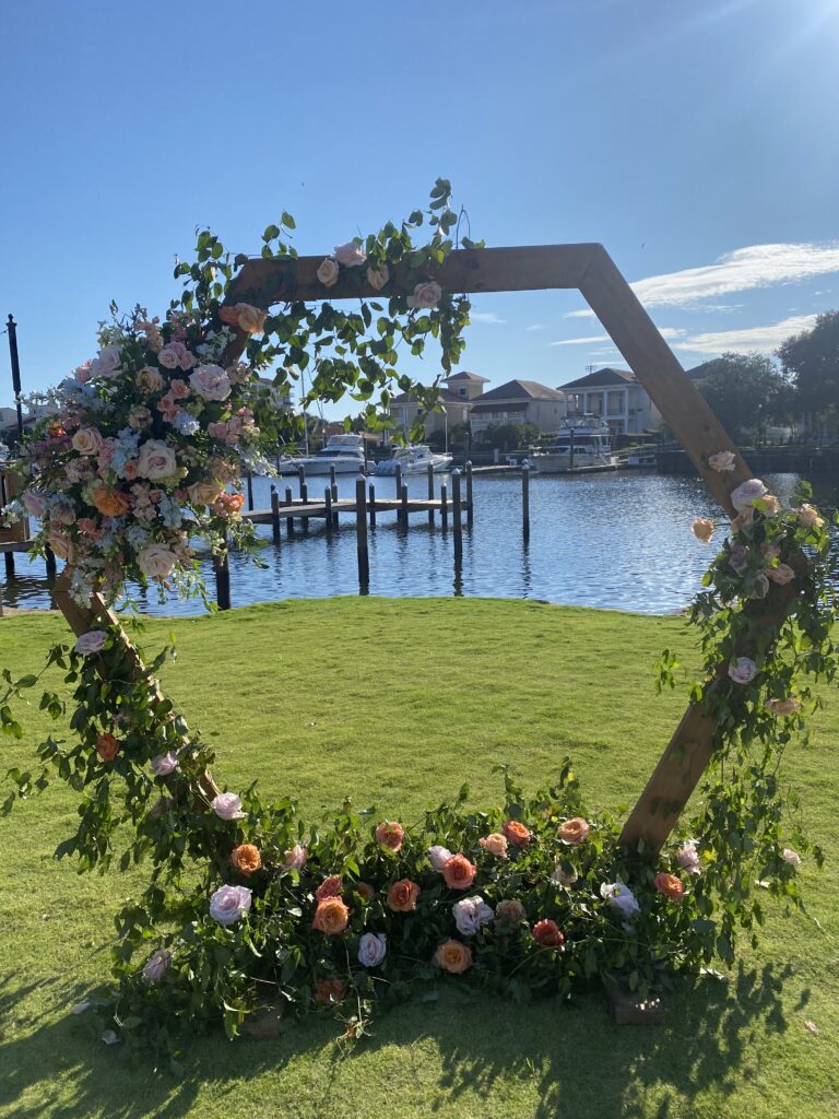 romantic octagon arbor for ceremony in september, the beginning of fall showing a shoulder month of the best months for your wedding in pensacola florida