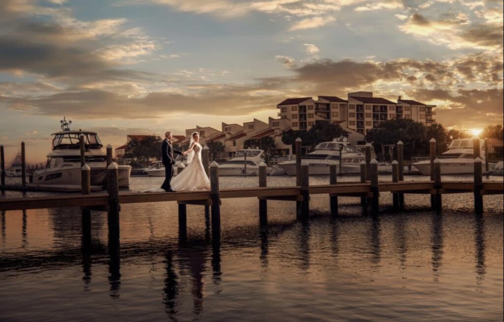 October Wedding couple on Palafox Wharf Waterfront Venue's dock enjoying gorgeous sunset