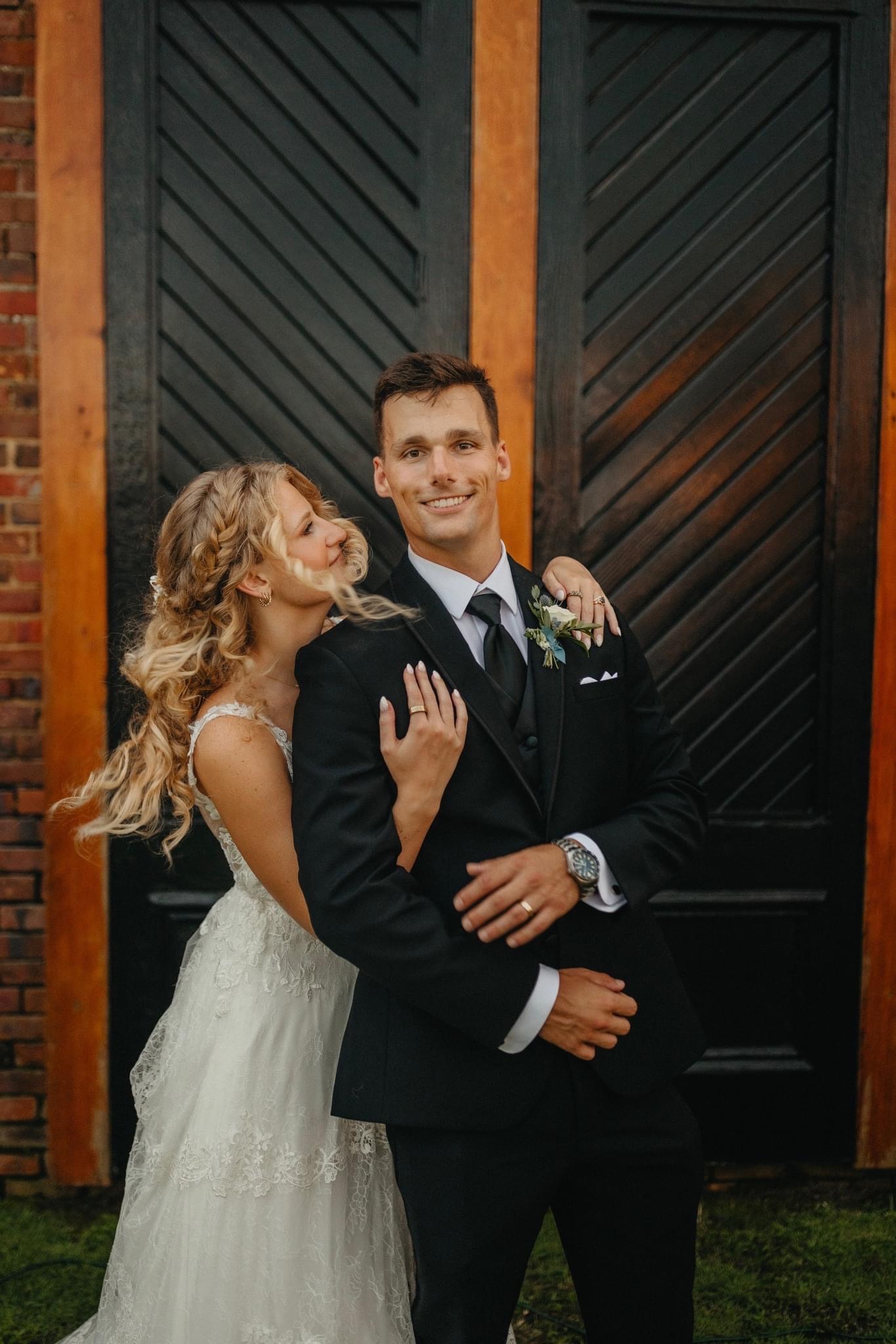 Just Married! Photo of Wedding bride & groom in front of the icon black doors on the green at Palafox Wharf Waterfront on the Emerald Coast in Pensacola, Florida and near wedding venues as well
