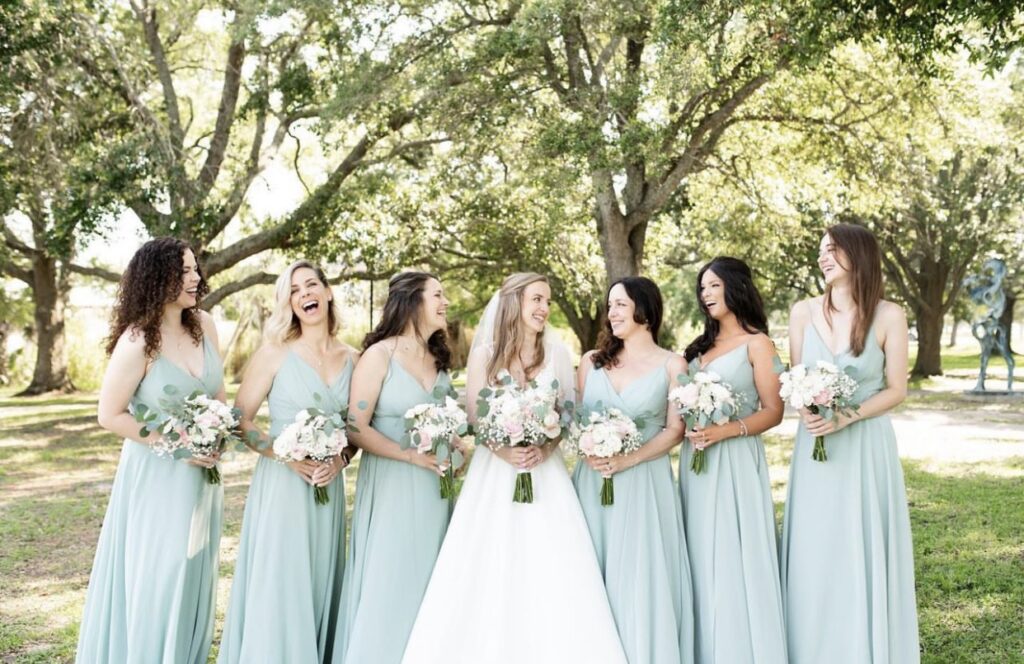 The Emerald Coast Wedding - Soft Blue Bridesmaid's Gowns with Ceremony at The Cathedral of the Sacred Heart and Reception at Palafox Wharf Waterfront Photography by Melissa Wilson Photo https://617palafoxwharf.com/ https://withthisringvideo.com/
