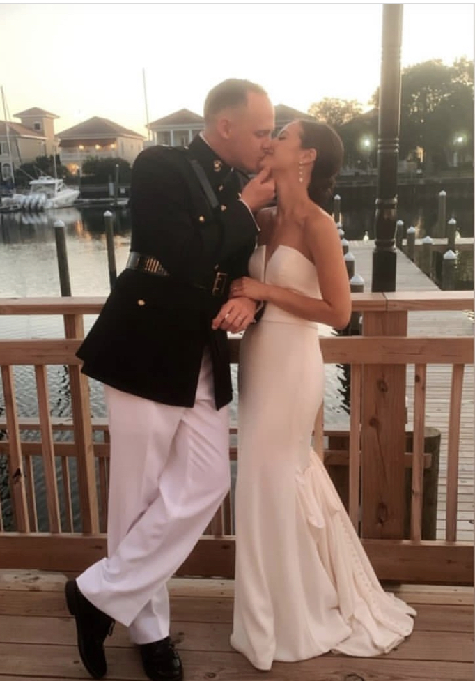 Couple kissing on waterfront deck at Palafox Wharf Waterfront Gulf Coast