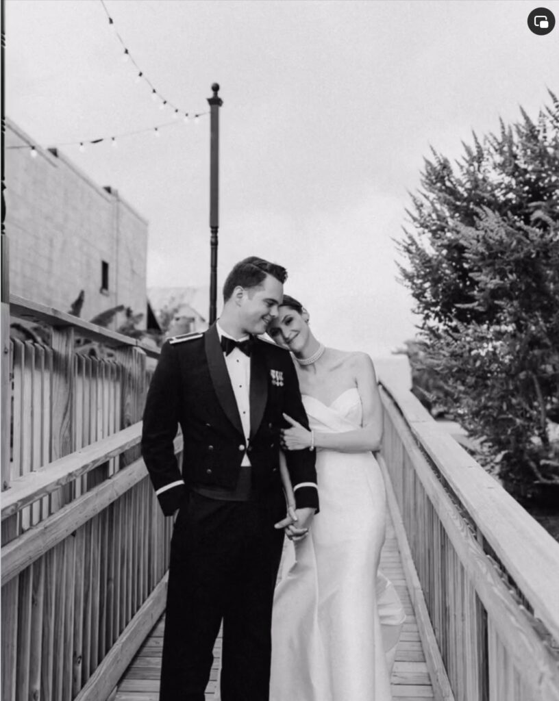 May couple at Palafox Wharf Waterfront Pensacola Florida outside on the ramp to the dock and on the waterfront green