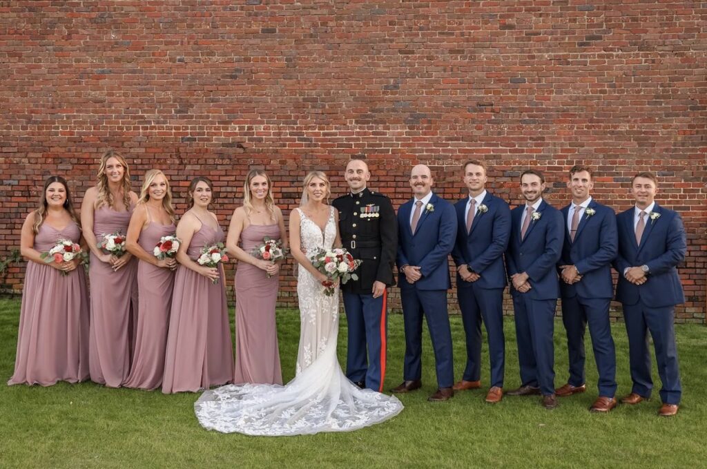 November wedding party on the green in blue and mauve attire at Palafox Wharf Waterfront Pensacola Florida Gulf Coast