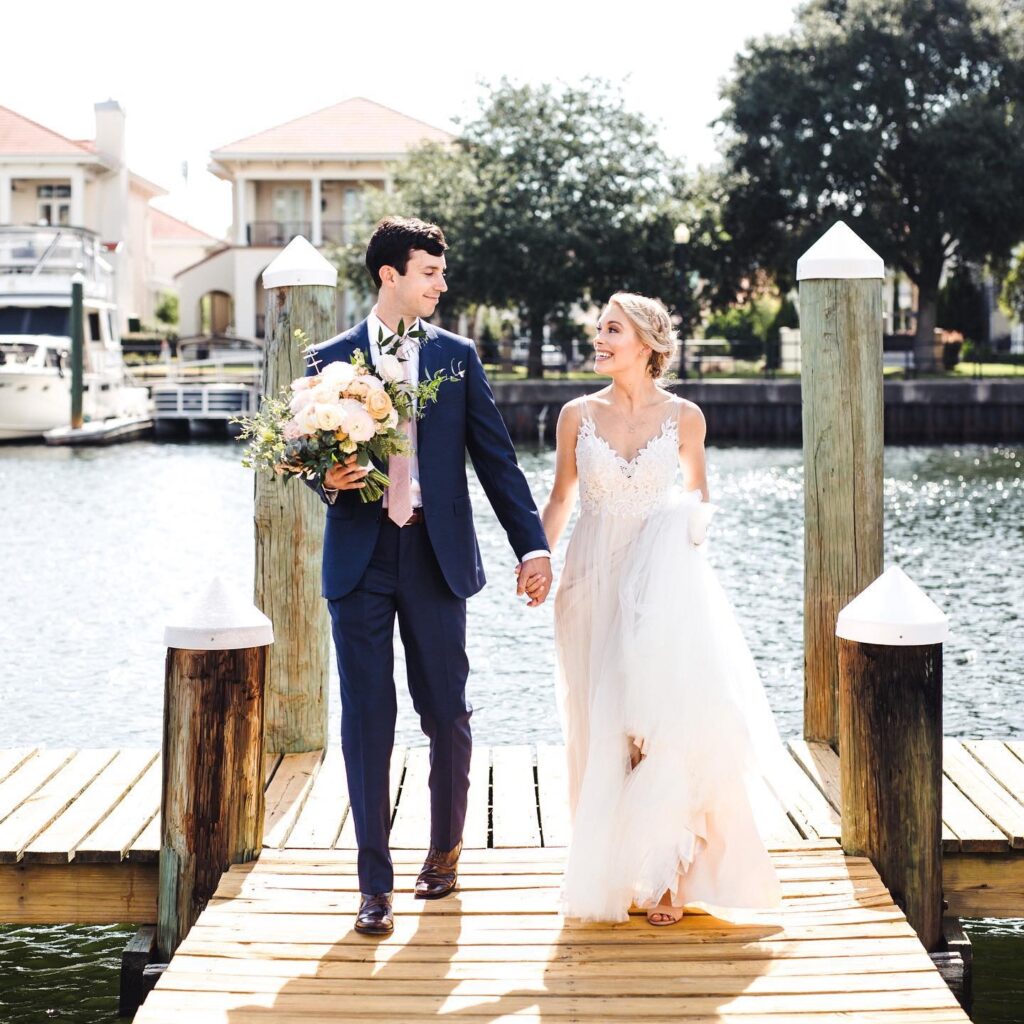 Smiling Alyssa + Kent on the Palafox Wharf Waterfront dock photo by Erika Smith, Indie Pearl Photography http://www.vineyardatstcharles.com/
