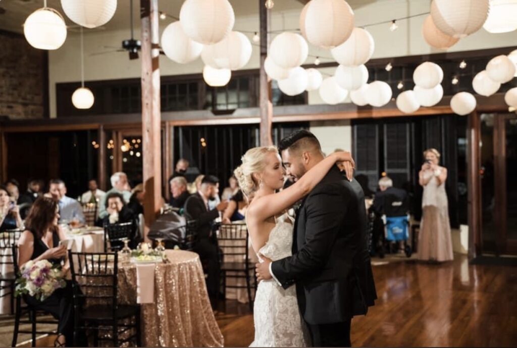 Destination Event and Wedding Couple's First Dance at Palafox Wharf Waterfront in Pensacola Florida with Bride, Chelsea and notice their beautiful Sweetheart Table
