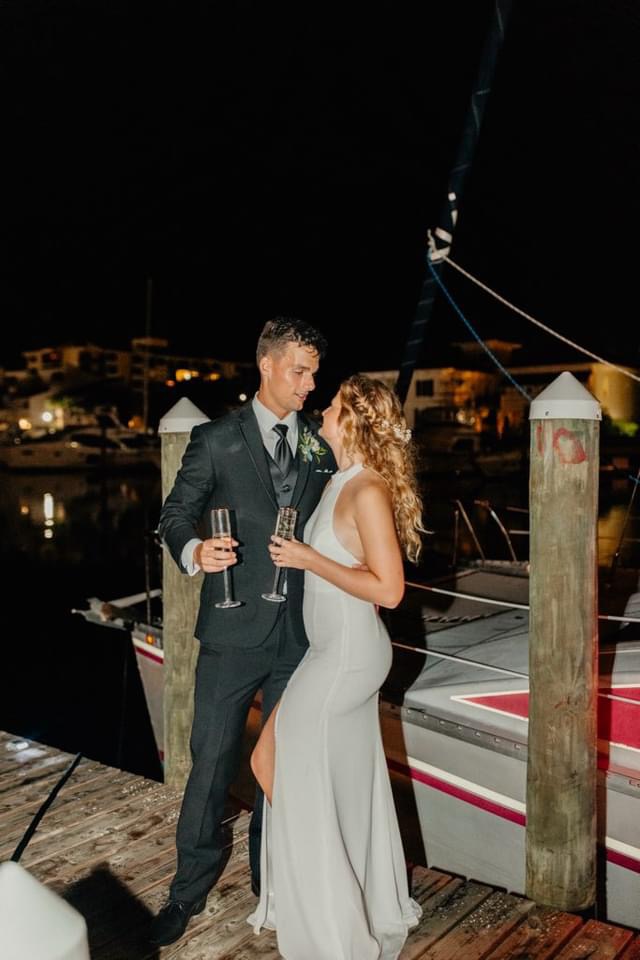 Discover 12 Advantages of Intimate Weddings Are Ideal at Palafox Wharf Waterfront you can enjoy what this Wedding and Event Destination Couple, groom in the military and bride in nursing, did! 
 Here this Couple poses for photo just before they take a 30 minute boat ride right after Cocktail Hour on Baylen Slip at Palafox Wharf Waterfront in Downtown Pensacola Florida