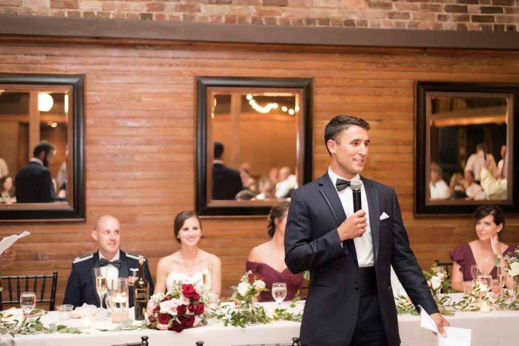 Wedding and Event Local Wedding Couple, groom in military and bride in nursing, during Reception inside Palafox Wharf Waterfront Venue with Best Man make his Toast to the Couple 