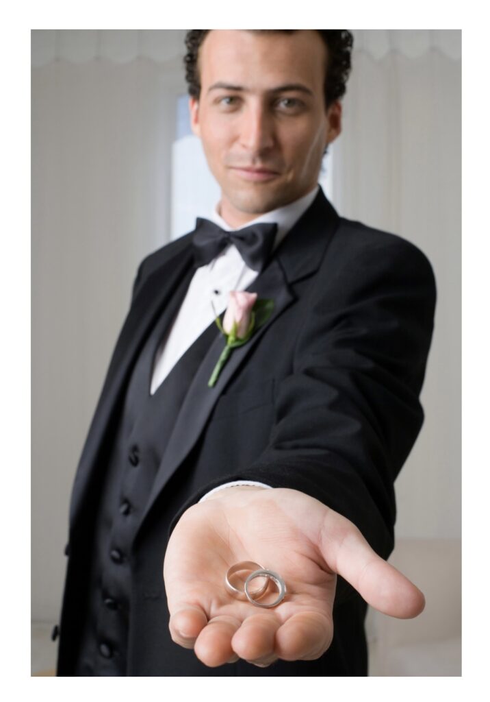 Pensacola and Destin Florida showing Best Man to the Groom dressed in black suit with black bowtie and soft pink flower on lapel https://617palafoxwharf.com/ https://ellasgarden.com/

