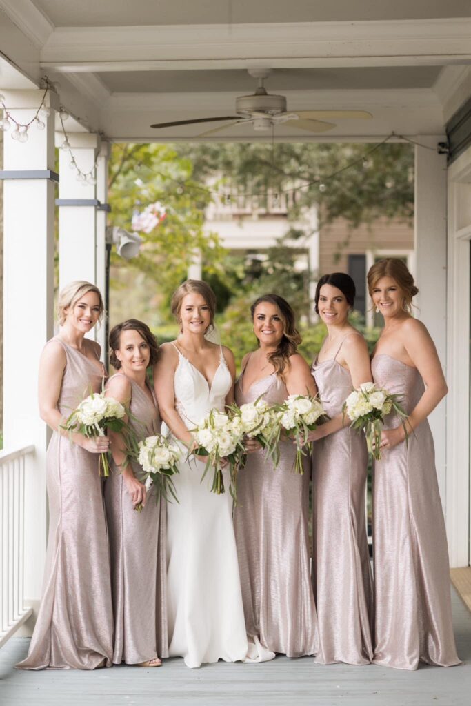 Near Pensacola Florida Bride and her girls in earthy, neutral tones with lush greenery and white florals for bouquets with Ceremony at Old Christ Church and Reception at Palafox Wharf Waterfront https://harrisglen.com/
https://617palafoxwharf.com/