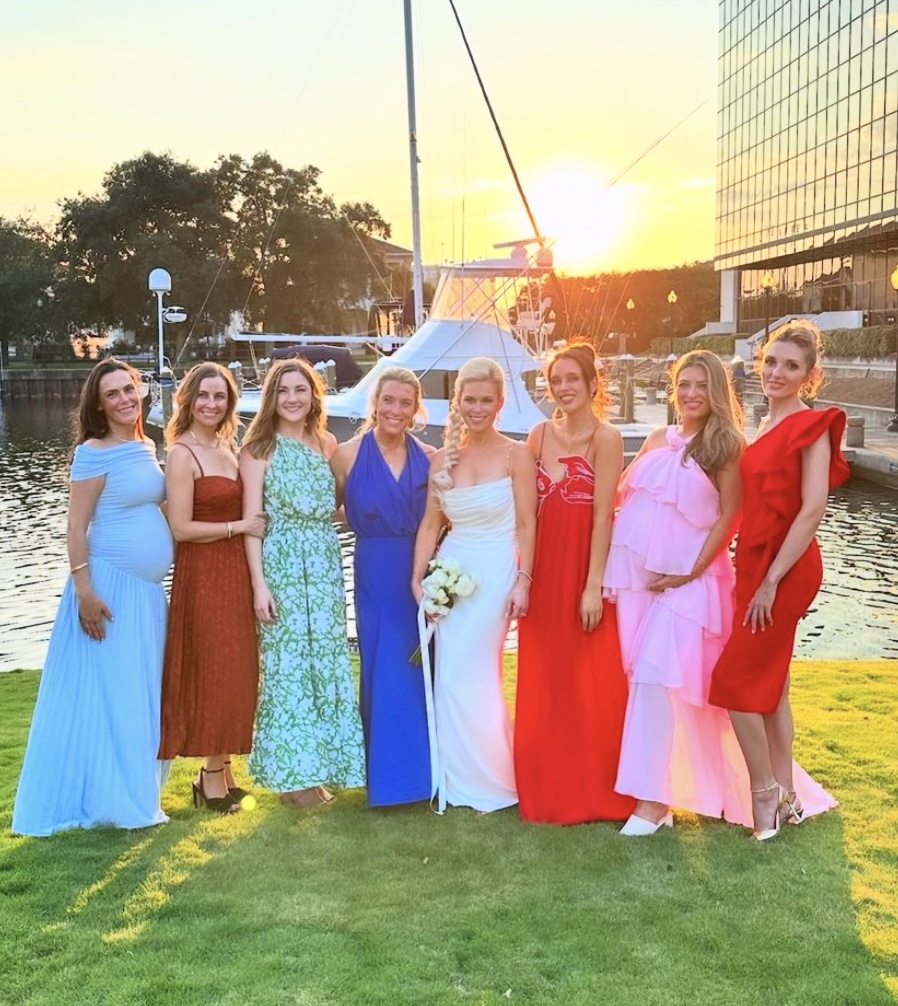 Guest Photo of Bride and her Girls at Palafox Wharf Waterfront showing brilliant red, perky pink sapphire blue, light blue, and an earthy green https://617palafoxwharf.com/ http://www.swanlakeoverlook.com/
