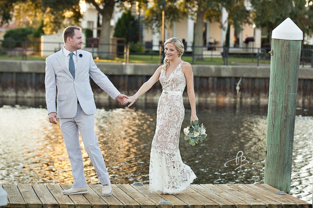 Bride smiles as groom gently encourages her to come along on the dock . photo by Patsy Brown Photography https://legacyfarmstn.com/ http://www.sunnysidefarm.net/
