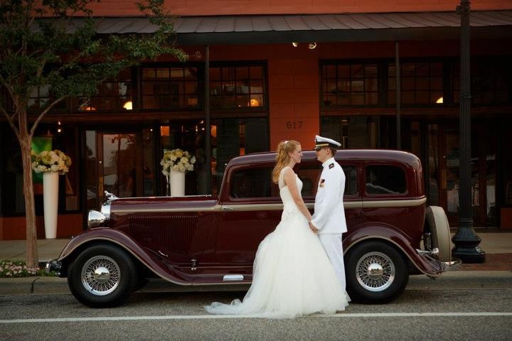 Vintage vehicle wedding moment outside Palafox Wharf Waterfront venue . Photo by East Hill Photo in downtown Pensacola walkable to hotels http://www.heartlandfarmseventcenter.com/ https://www.hanoverreserve.com/ 
