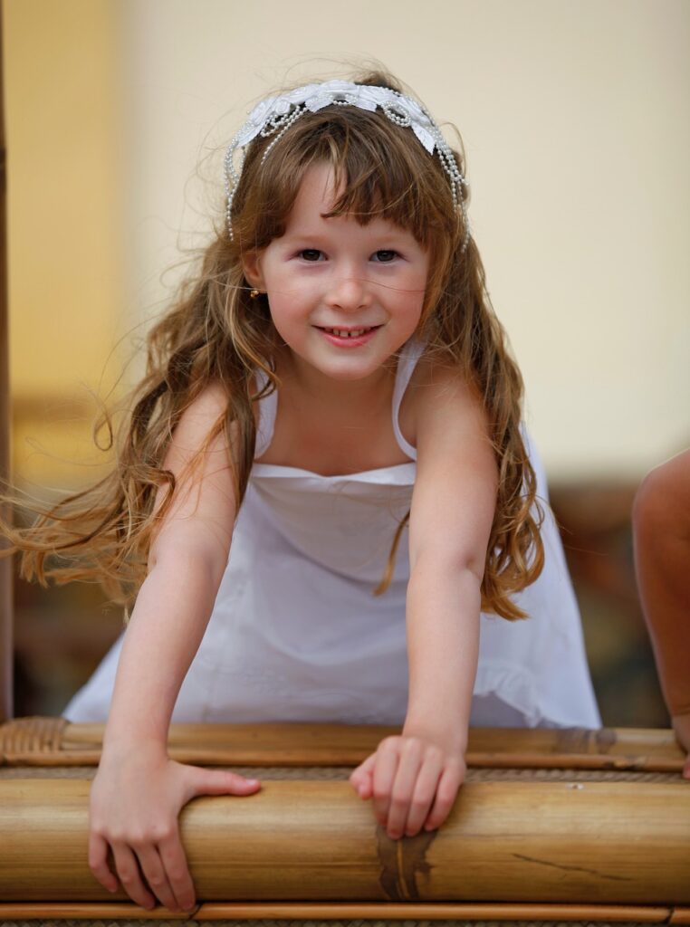 Smiling child standing up on a pew at church https://www.cakesrockaustintx.com/ https://www.farmweddingde.com/