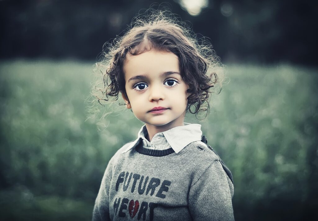 How cute is this child?  Adorable with brown hair, big brown eyes, wearing a gray sweatshirt with gray shirt underneath.  https://ballengerbridge.com/ https://617palafoxwharf.com/