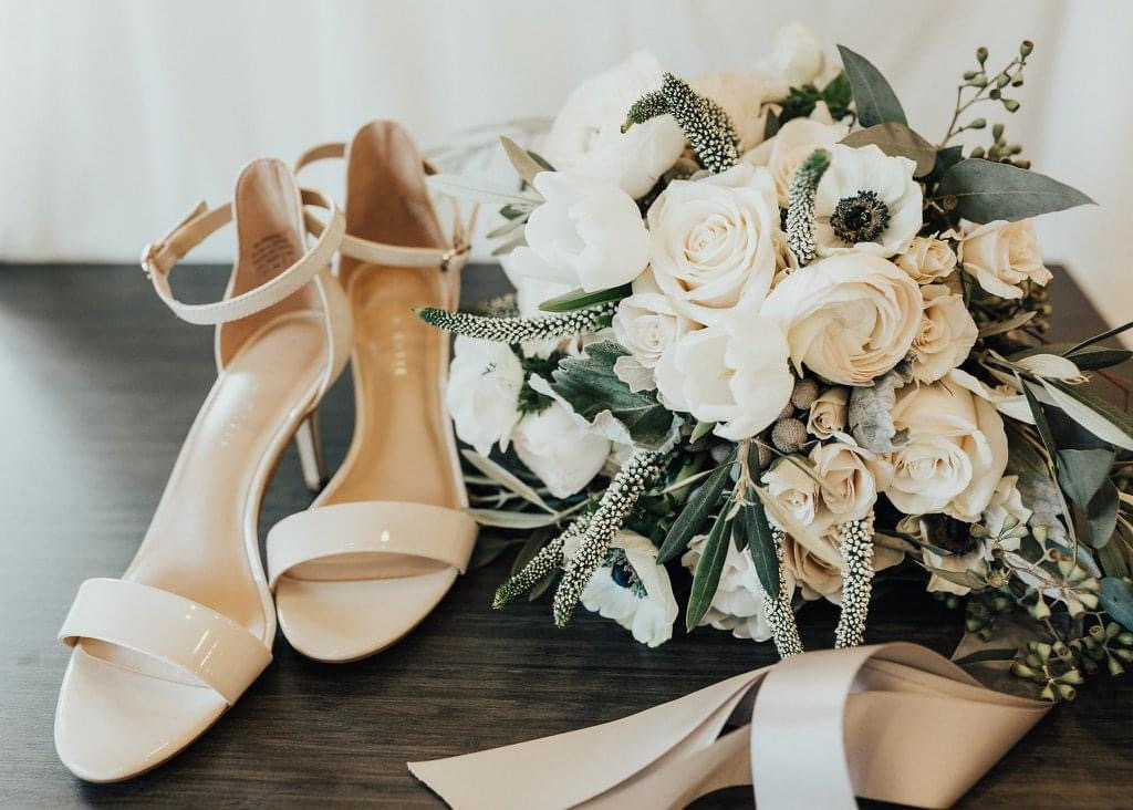 Bride’s ivory shoes and bouquet photographed Palafox Wharf Waterfront near Pensacola FL and near Destin