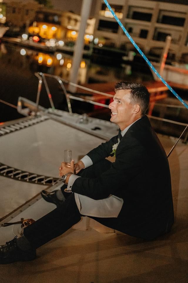 Groom (Bride as well however not in photo) at Pensacola's Downtown Palafox Wharf Waterfront taking a brief ride for two, providing a peaceful escape . Photo by Juls Drake Photography https://topekasocial.com/wedding https://all4onefarms.com/