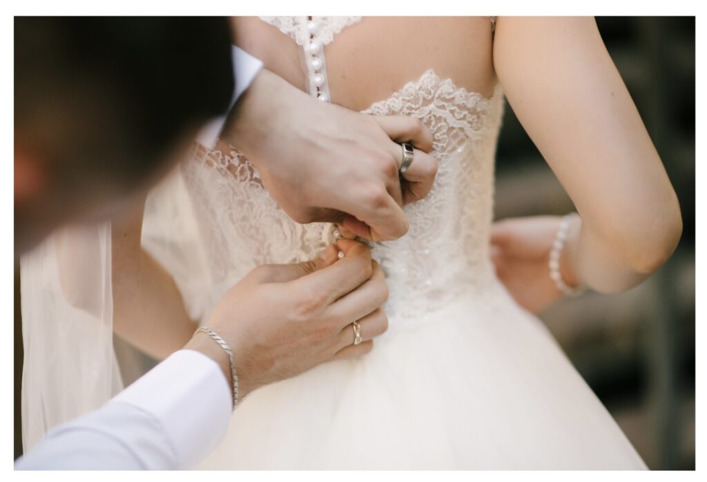 Pensacola Destin Florida Planner helping with the very tiny buttons on Bridal Gown https://www.adlerranch.com/contact-us
https://www.thevenue112.com/contactus
