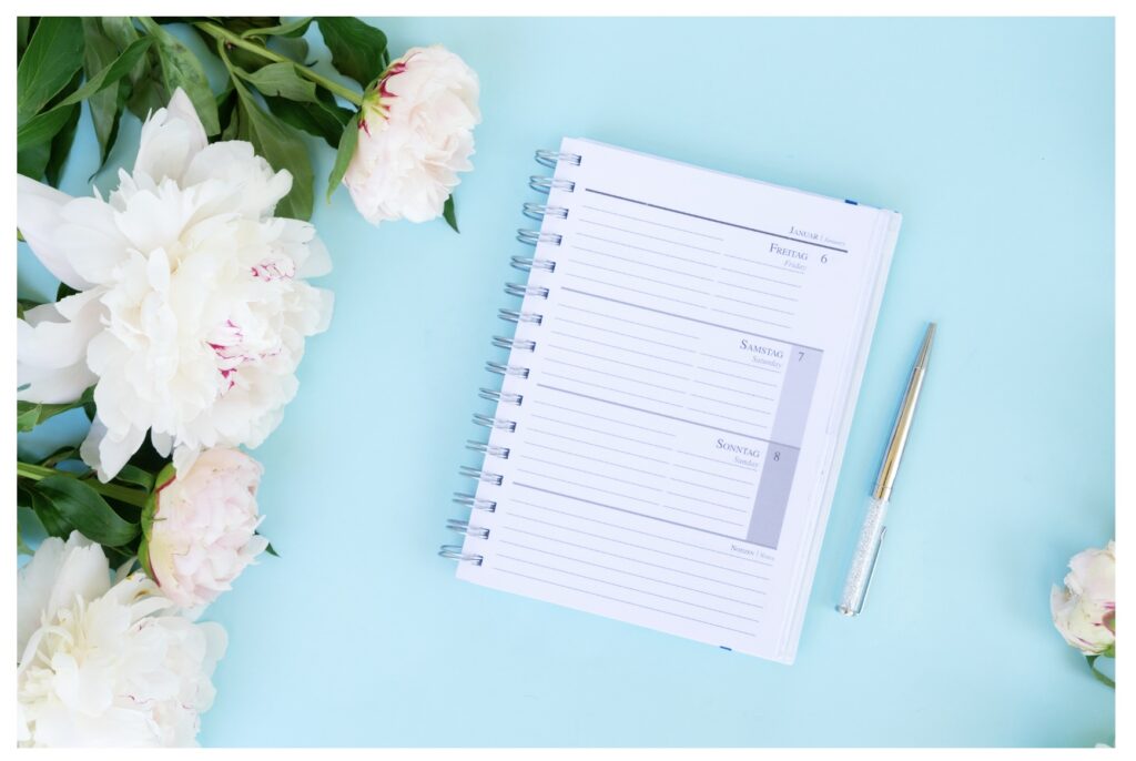 Peonies and Host's calendar on turquoise background Pensacola Destin Florida https://617palafoxwharf.com/ https://www.thecreekhaus.com/
