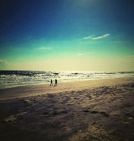 Pensacola Florida's Palafox Wharf Waterfront Venue suggests enjoying a romantic walk on the beach at sunset 