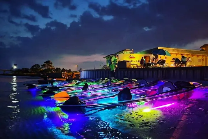 Pensacola Florida's cool and romantic date night idea is to paddle board on glowing paddle boards! https://617palafoxwharf.com/