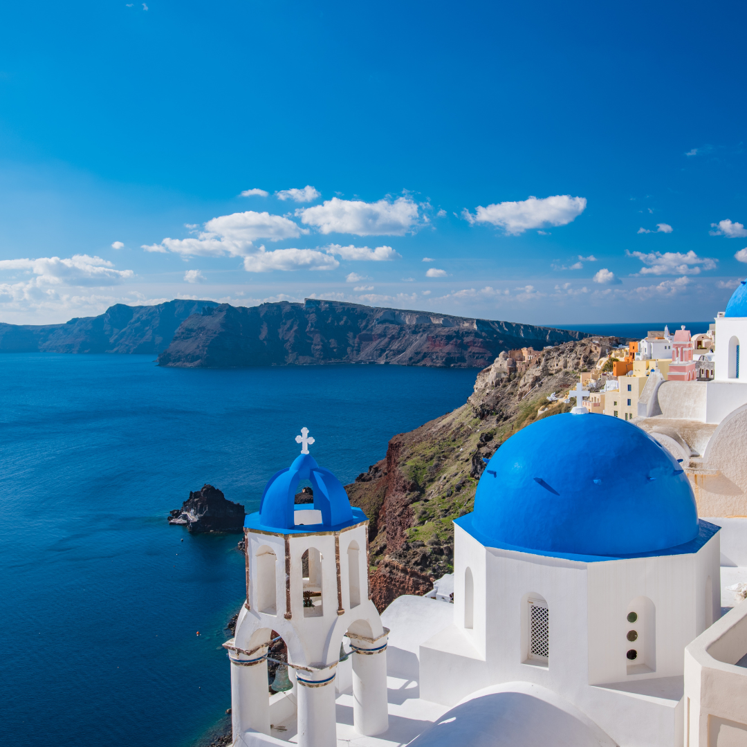 Near Pensacola Wedding Venue and this is Popular honeymoon location is Santorini, Greece with the blue and white buildings and mountains with the beautiful blue water and sky