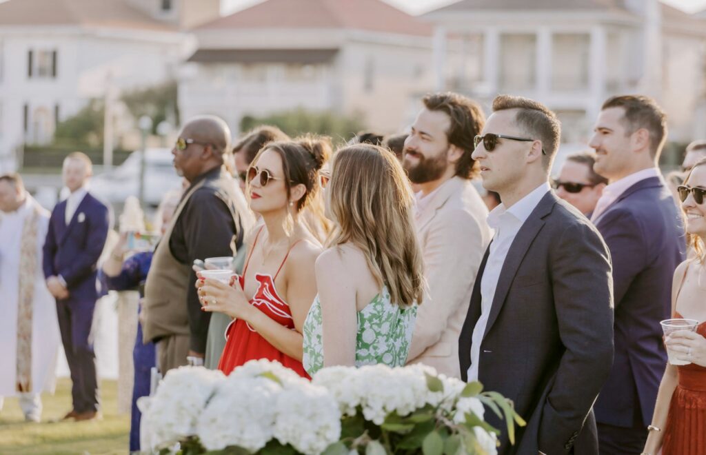 Guests asked to stand for the Bride walking down the aisle to her Groom at Palafox Wharf Waterfront Ceremony on the Green near Pensacola Florida events