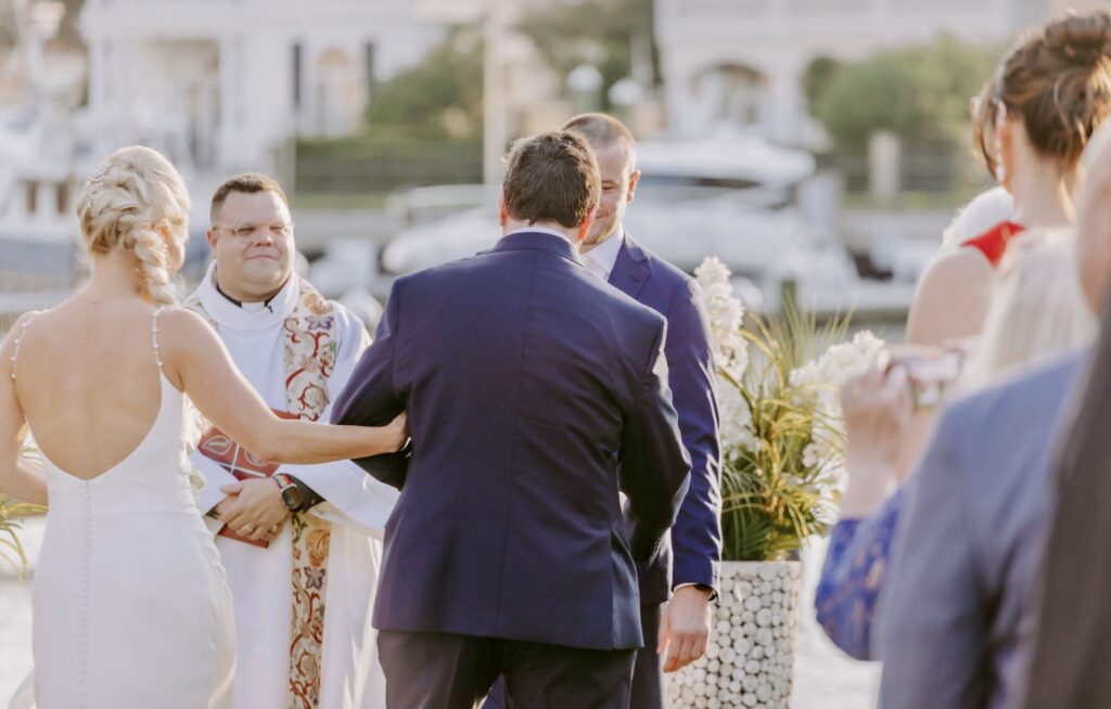 Bride's Dad meets Groom with Bride on the Green Lawn.  At Palafox Wharf Waterfront near Pensacola FL.  Near Destin FL