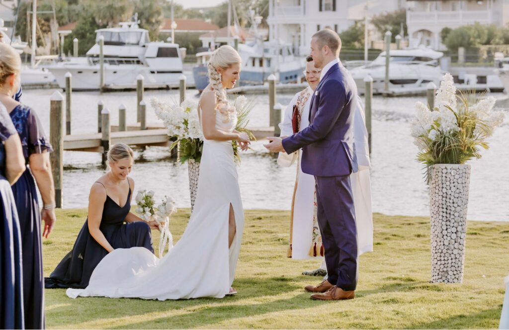 Maid of Honor adjusting Bride's train just before the minister begins the Ceremony.  near Pensacola FL near Destin FL