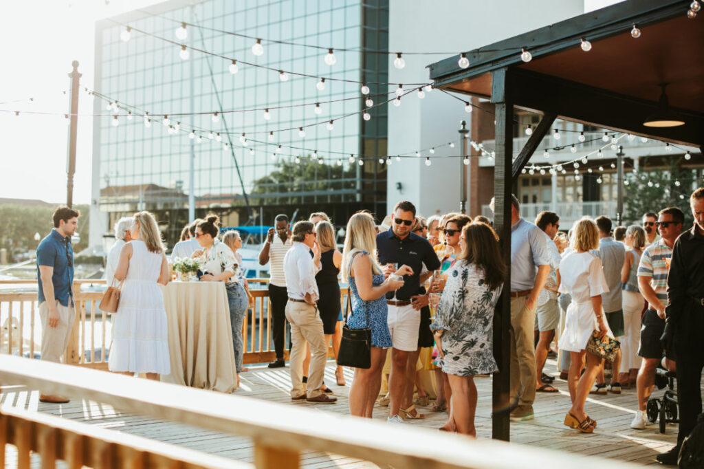 Guests for the cocktail party enjoying the late afternoon affair on the waterfront at Palafox Wharf Waterfront Pensacola Florida near Destin. Garden & Gun’s Scenic Downtown Cocktail Party at Palafox Wharf Waterfront