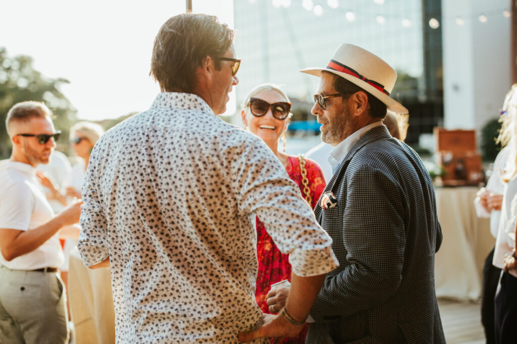 Close up of a few guests for Garden & Gun’s cocktail party on the Palafox Wharf’s waterfront Deck. Garden & Gun’s Scenic Downtown Cocktail Party at Palafox Wharf Waterfront