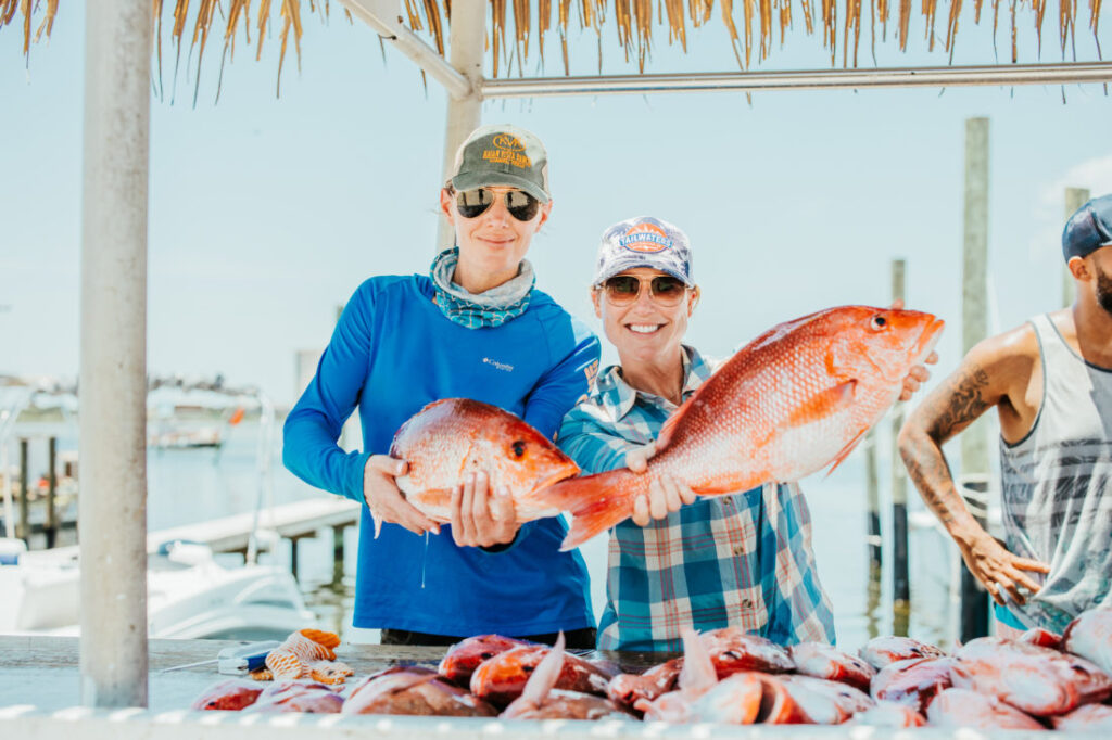 Guests enjoyed a fishing trip and here are two society members of Garden and Gun showing off their catch in Pensacola Florida near Destin