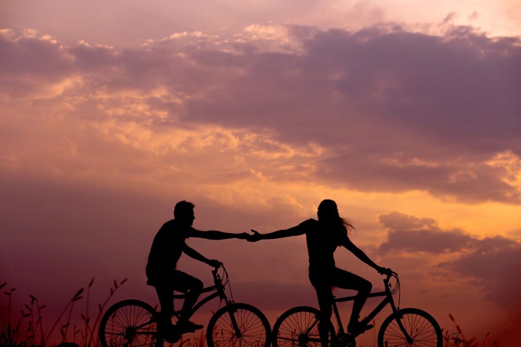 Pensacola FL near Destin FL couple enjoying some time riding bikes together after reading through the Newly engaged couple home-buying guide