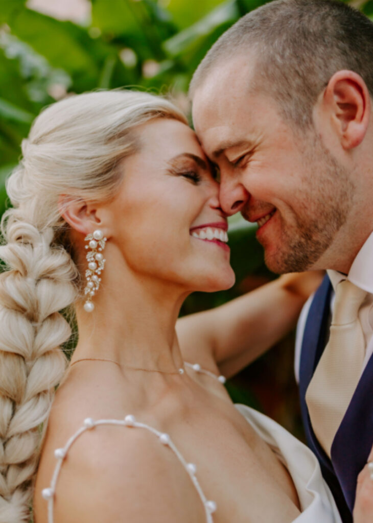 Waterfront wedding bride with braided hair with groom - Hair and Makeup Tips for Florida Brides