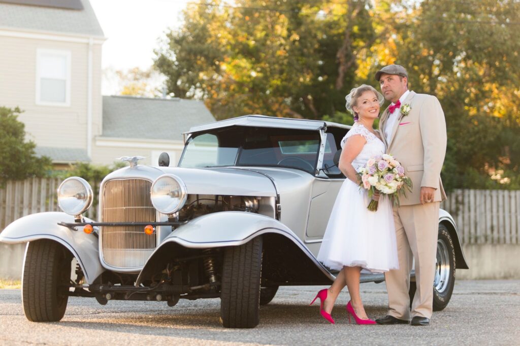 Event Venue Palafox Wharf Waterfront Downtown FL
Palafox Wharf couple posing in front of their silver vintage getaway vehicle