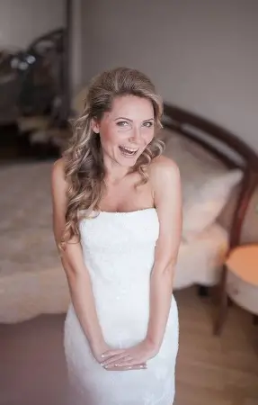Bride all smiles with a prenup agreement in white dress
