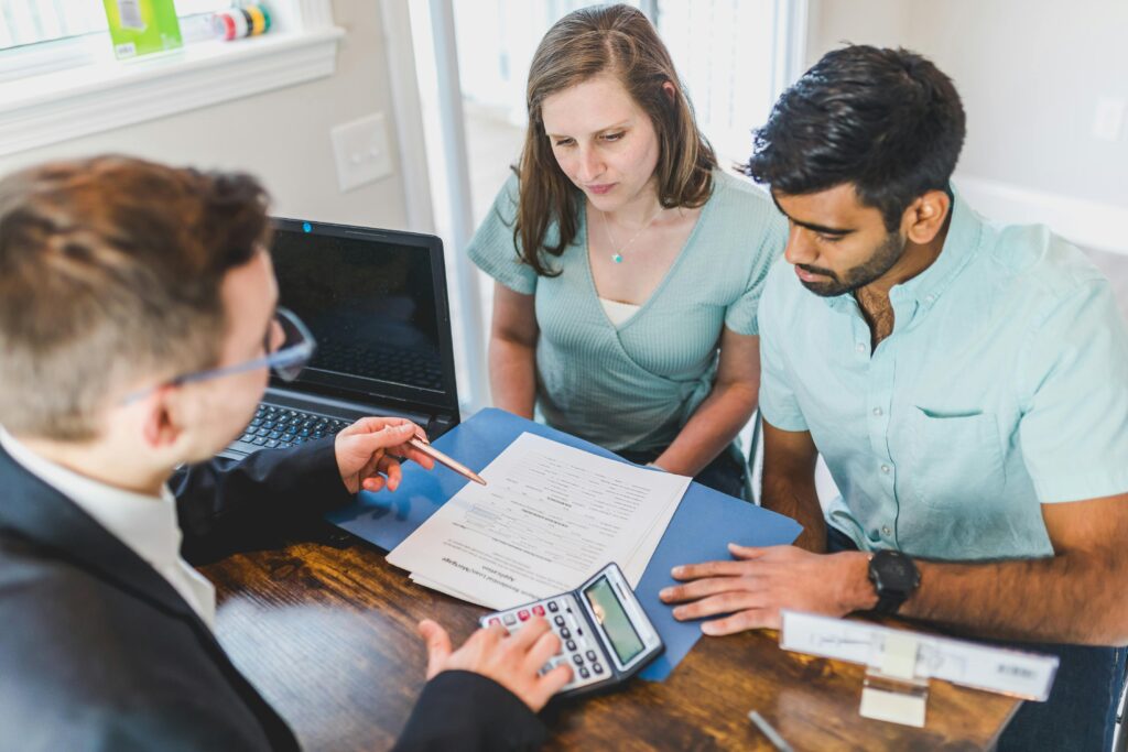 Couple visiting financial counselor to gather more information about their finances and pre-nup agreement