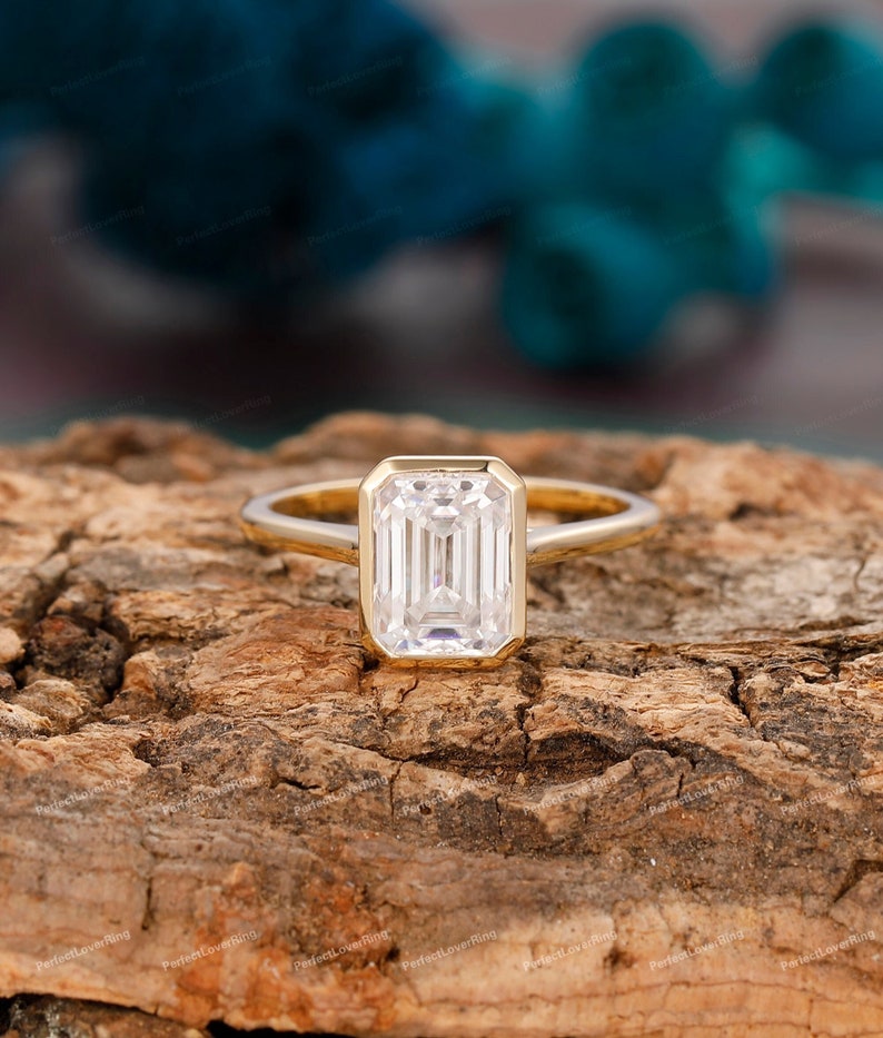 Palafox Wharf Wedding Venue shows Vintage 2CT/3CT Emerald Cut Moissanite Engagement Ring/ Anniversary Ring For Women/ Bezel Set Wedding Promise Ring/ Gold Ring/ Proposal Ring