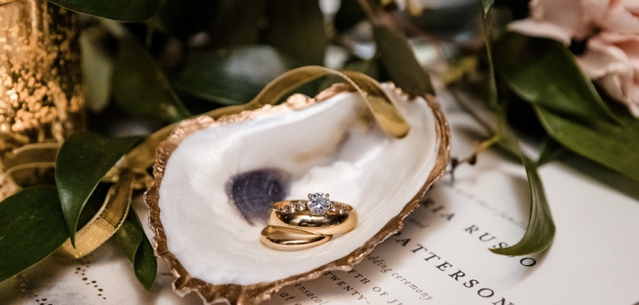 Just Married Couple's Wedding and Engagement Rings for Reception at Palafox Wharf Waterfront Wedding Venue with a Gorgeous Elegant Gold Metal Bands and Diamonds 