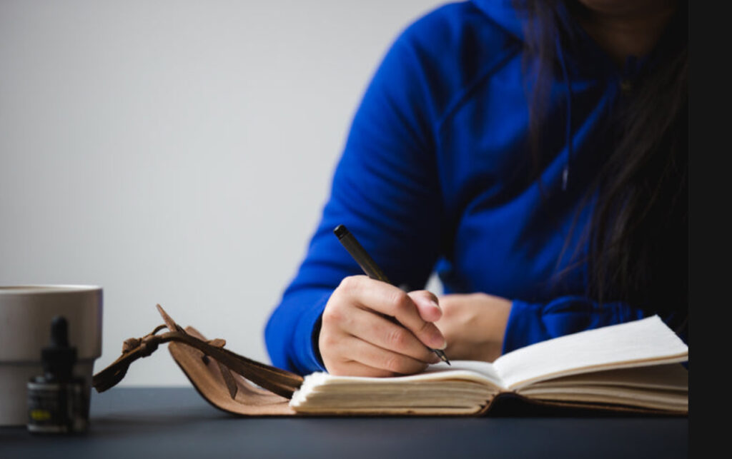 Bride planning her wedding is journaling and she is Palafox Wharf Waterfront Wedding Venue bride