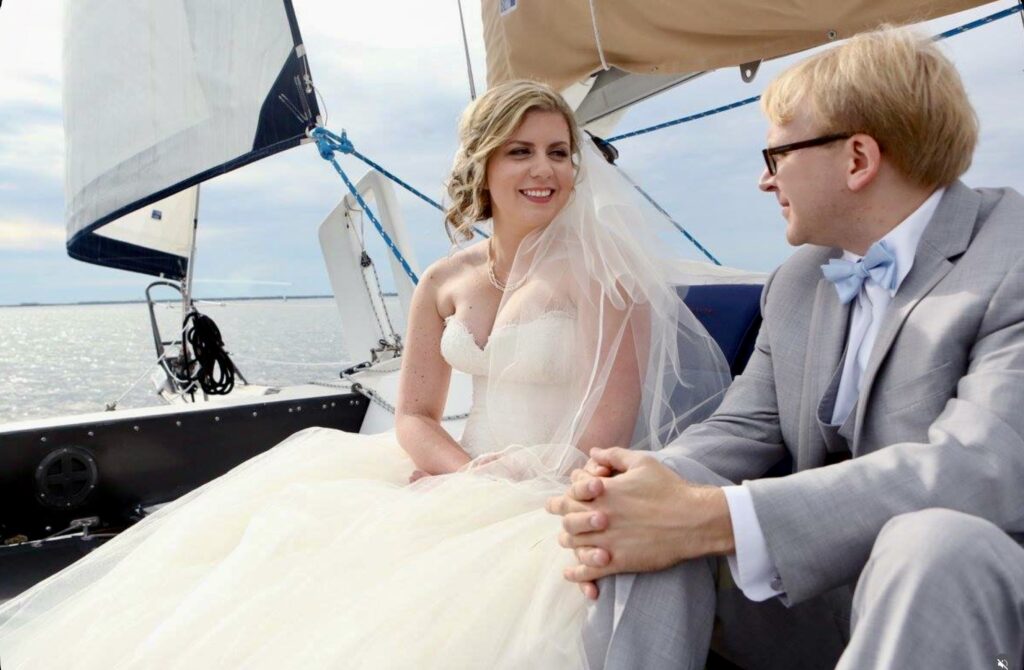 Photo of a Palafox Wharf Waterfront Wedding and Event Venue Couple.  In a short Boat ride on Pensacola Bay, this Palafox Wharf Waterfront Wedding couple is enjoying the relaxing luxury and being in the moment.  