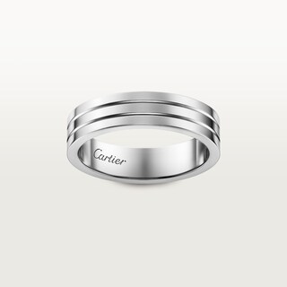 Palafox Street Venue known as Palafox Wharf Waterfront presents the Groom's sterling silver Cartier men's wedding band with 3 indented lines.