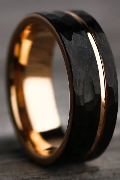 Palafox Wharf Waterfront on Palafox Street presents Groom's wedding ring making a strong statement in black with a thin gold ring in yellow gold metal.  Luxury black and good groom's ring.