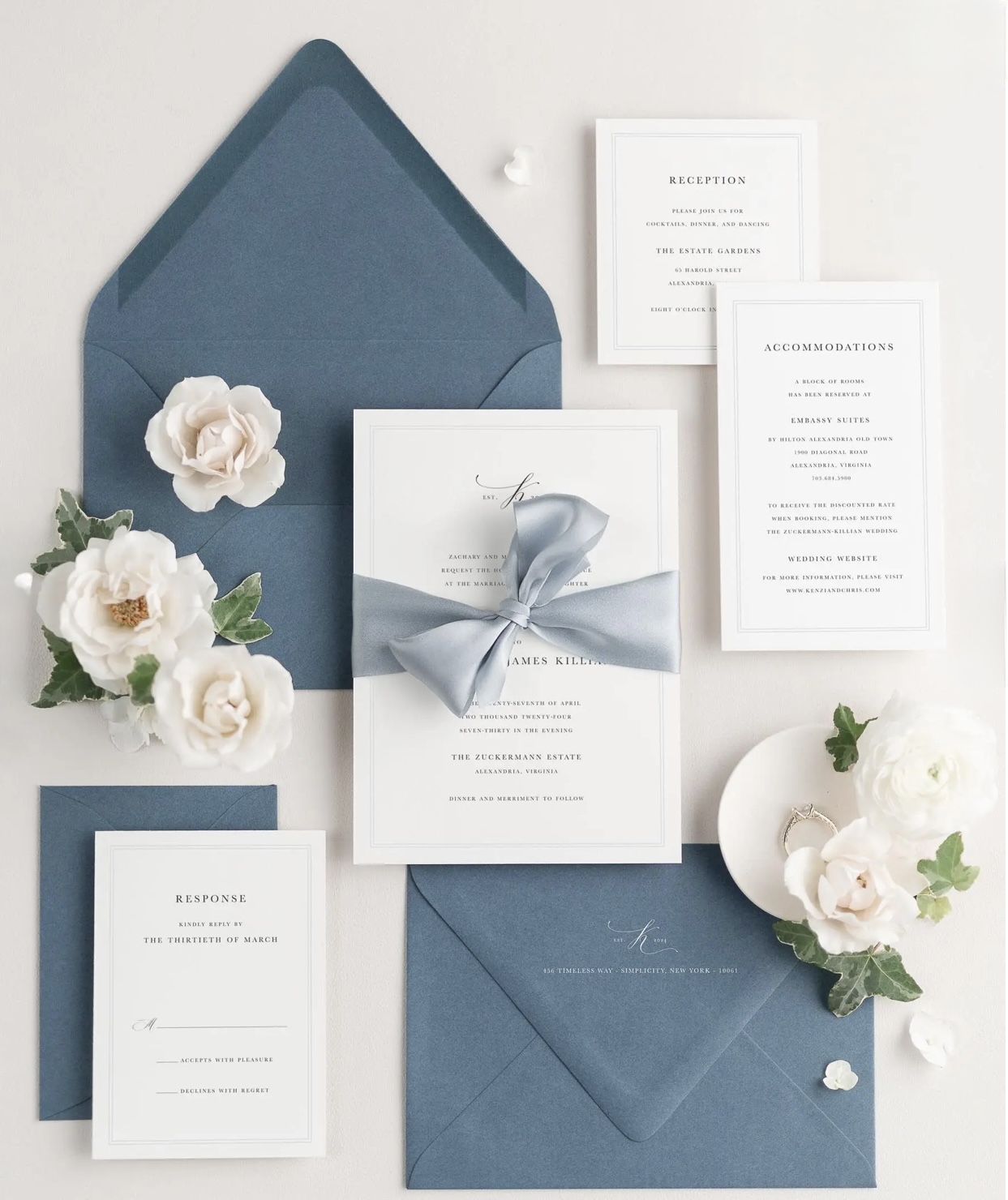 Blue invitation suite with florals and blue ribbon