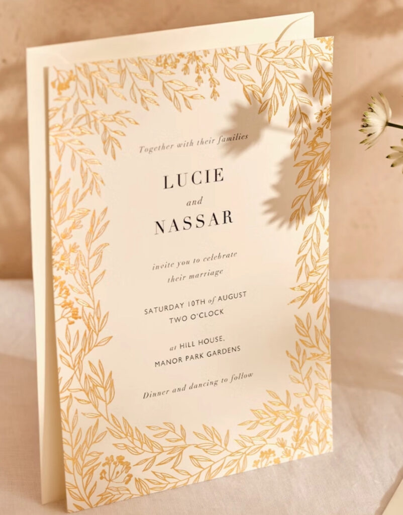 Wedding venues near Escambia county school district, FL is Palafox Wharf Waterfront Wedding Venue with cream invitation for a celebration of marriage in yellow leaves and black lettering